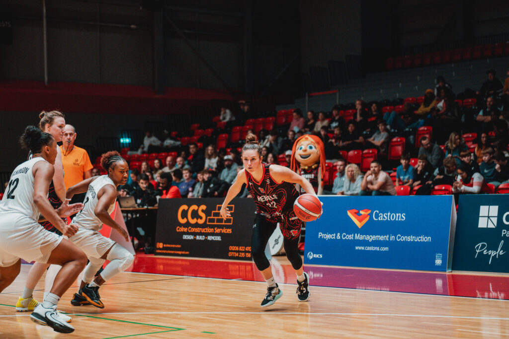 female basketball player attacking the basket