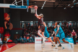 female basketball jumping for a layup
