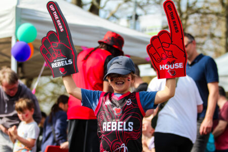child in Rebels gear happy
