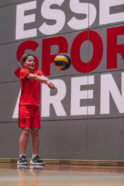 young girl playing volleyball and digging