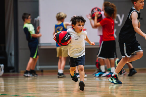 child dribbling the basketball