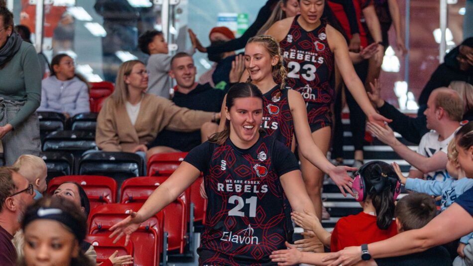 Paige Meyer and Rebels team high fiving the crowd