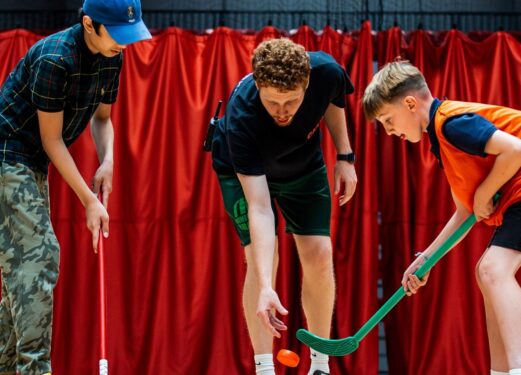 Juniors-playing-hockey-with-practioner